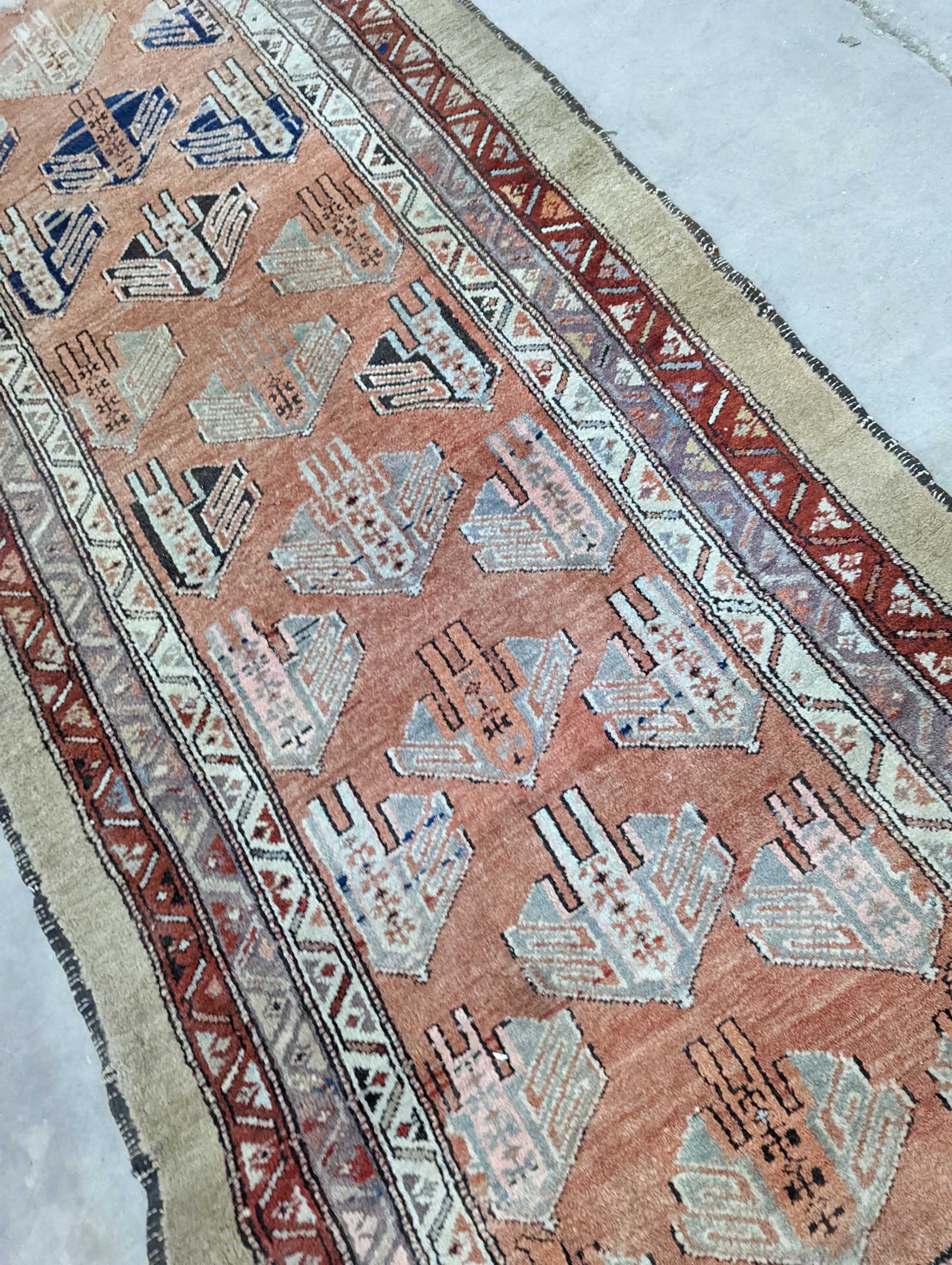 An Afghan brick red ground geometric runner and a smaller Afghan rug, larger 306 x 106cm
